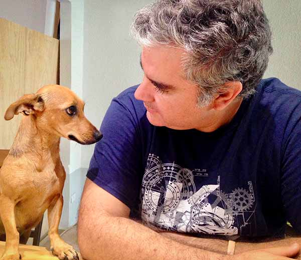 Photography of a dog and a man facing each other